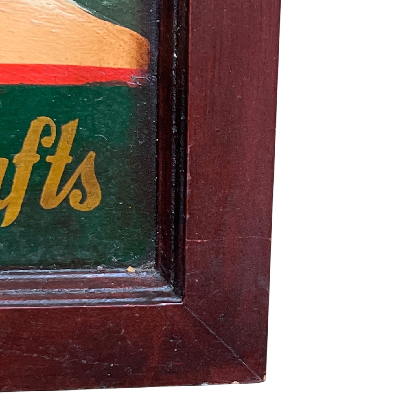 Corner of a vintage sign on a green background, framed in dark wood.