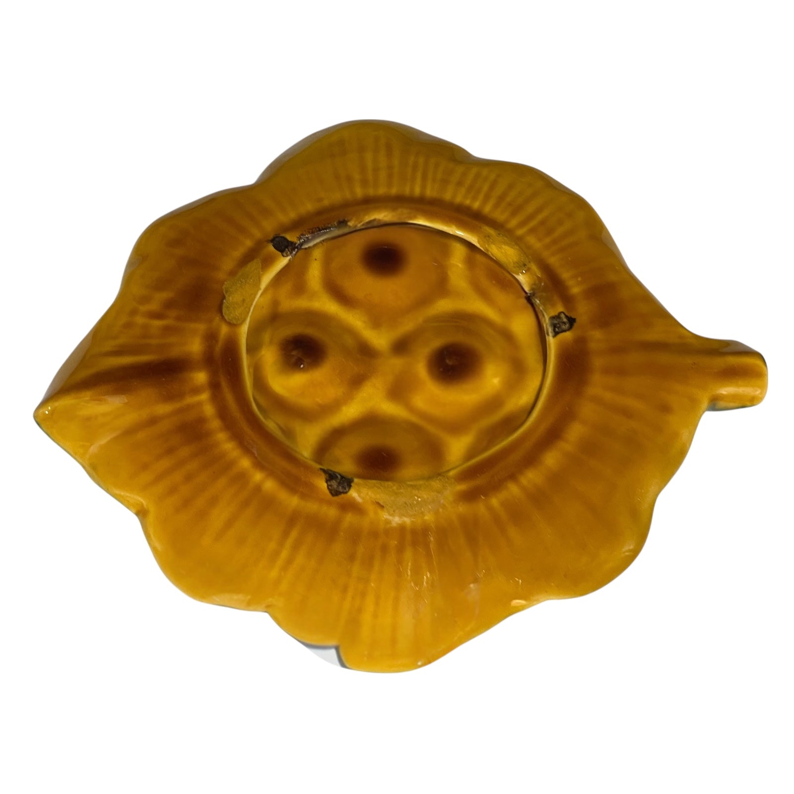 Back of a ceramic leaf-shaped snail escargots plate on a white background