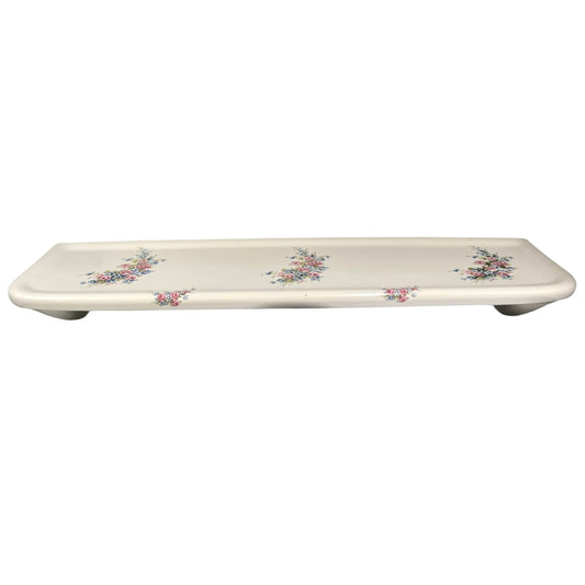 A French vintage ceramic shelf white with a floral pattern on a plain white background.