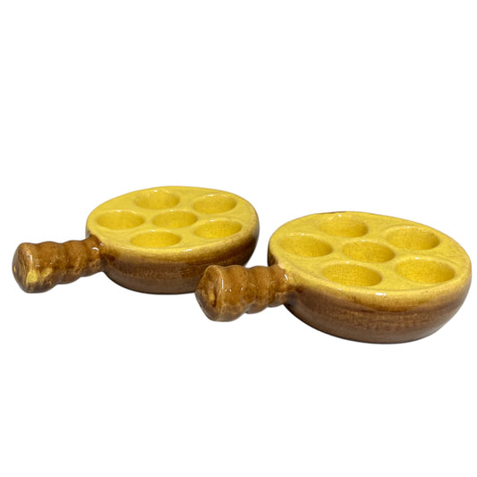 2 French vintage ceramic escargot serving plates, yellow inner with a brown exterior, each has 6 holes, shown on a white background