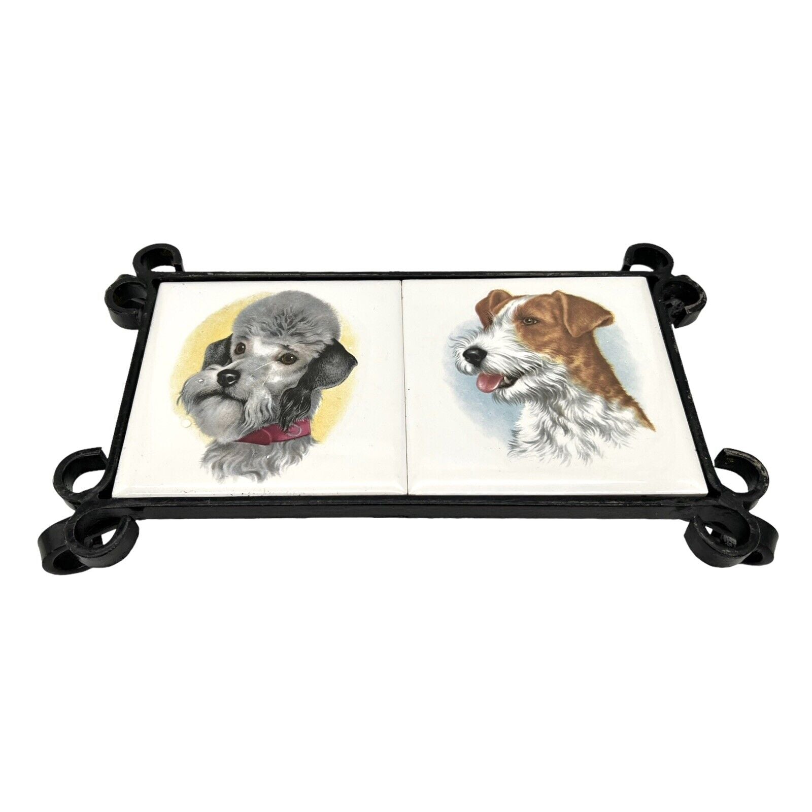 French tile topped pan trivet with an iron frame and 2 tiles -  dog pictures on a white background