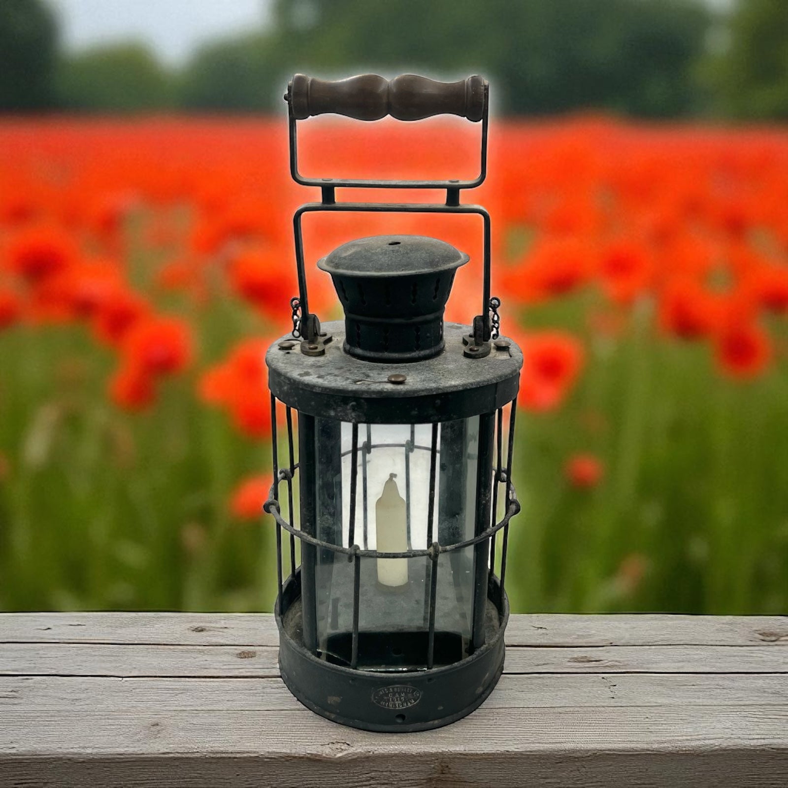 Vintage lantern on a wooden surface with a blurred background of red flowers