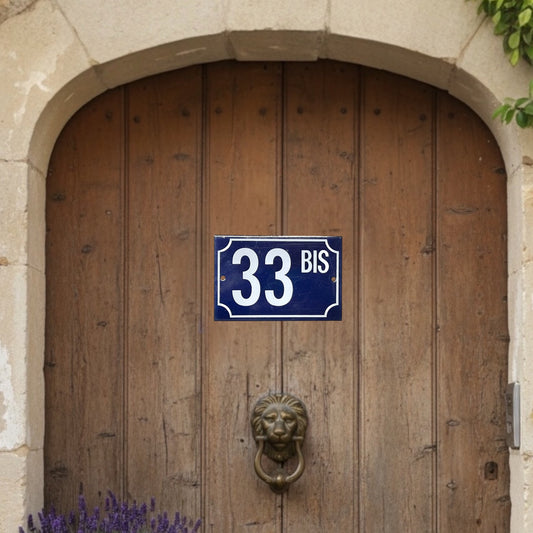 French vintage enamel blue and white door number on a wooden arched door