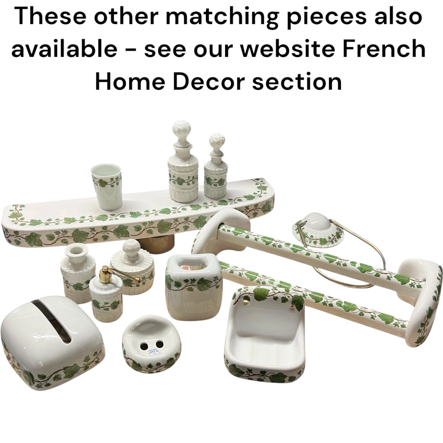 Set of porcelain bathroom items with green floral patterns on a white background.