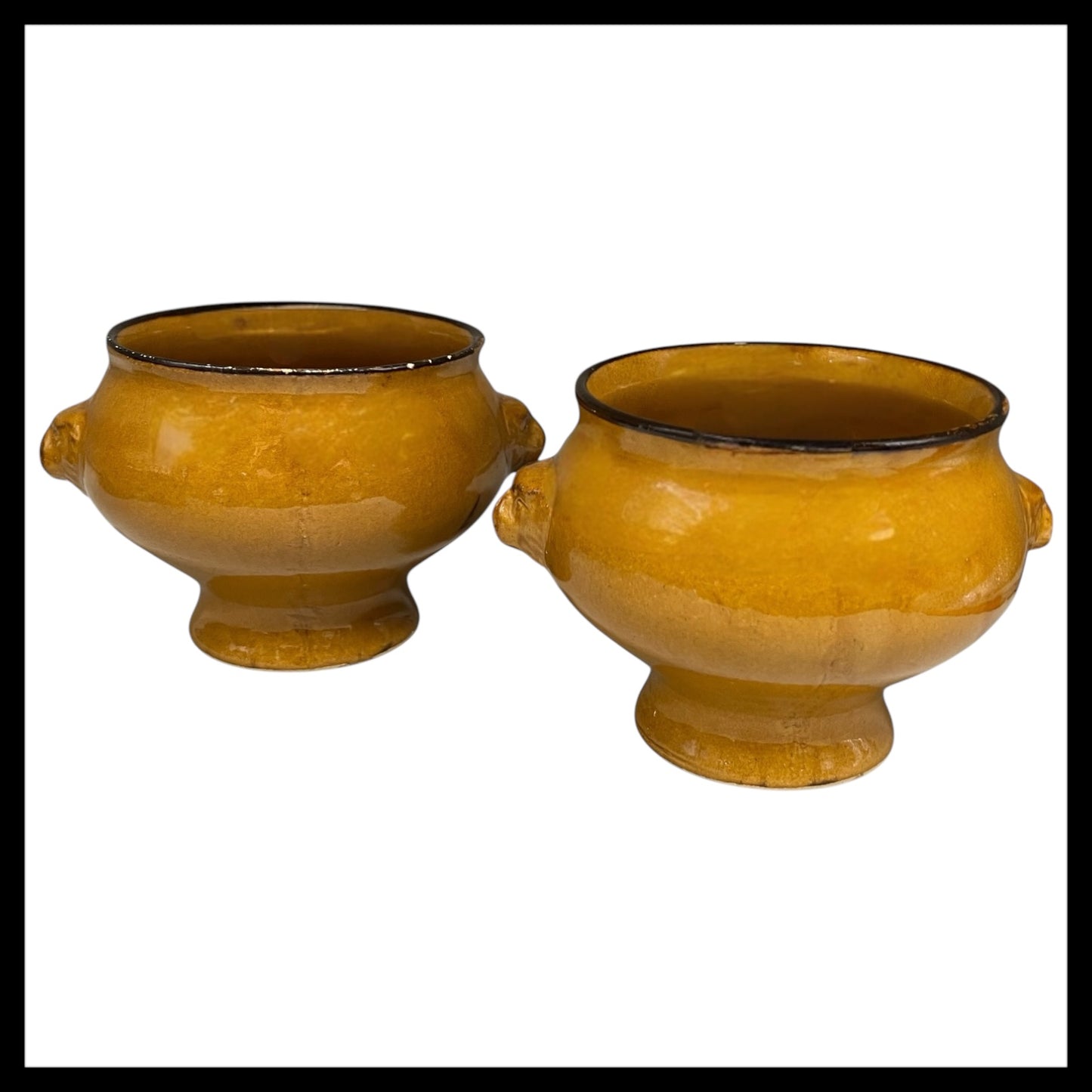 Pair of amber and brown coloured glazed ceramic French Lions Head Handle Bowls for sale by All Things French Store