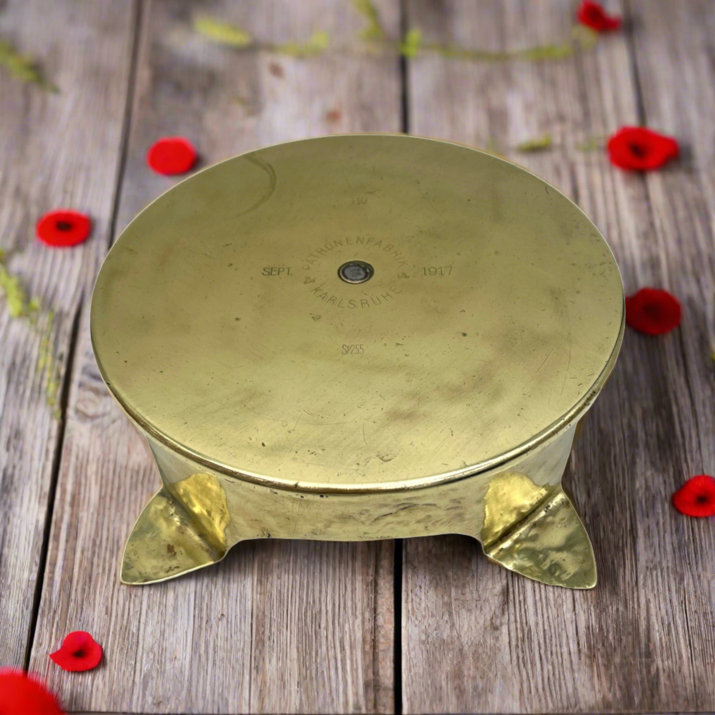 brass pan trivet of plant stand on a wooden table