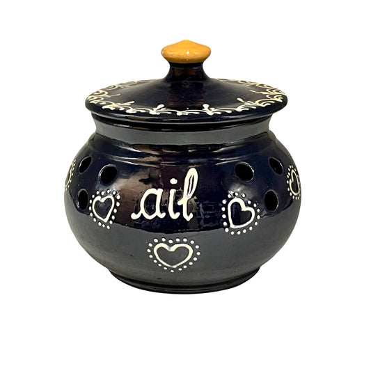 Blue ceramic pot with decorative hearts and the word 'ail' on a white background