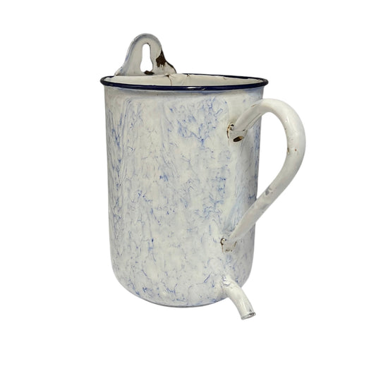 A vintage enamel pitcher with a white marbled pattern, a dark blue rim, a top carrying loop, and a side spout, shown on a plain white background.