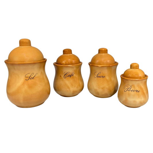 Four ceramic canisters with matching lids in a warm marbled tan and ochre colour, labelled 'Sel', 'Café', 'Sucre', and 'Poivre' in black cursive script, arranged from largest to smallest on a white background.