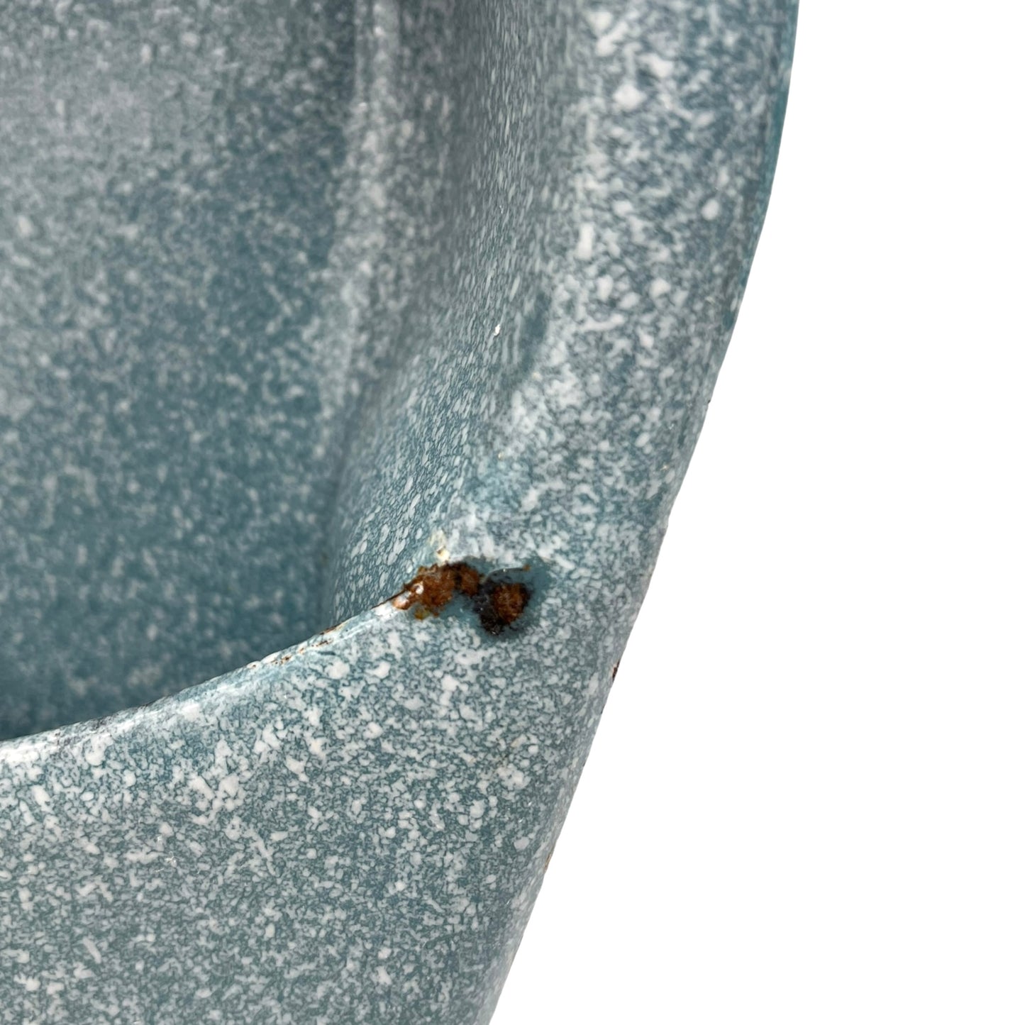 Close-up of wear and tear on a blue metal planter on a white background
