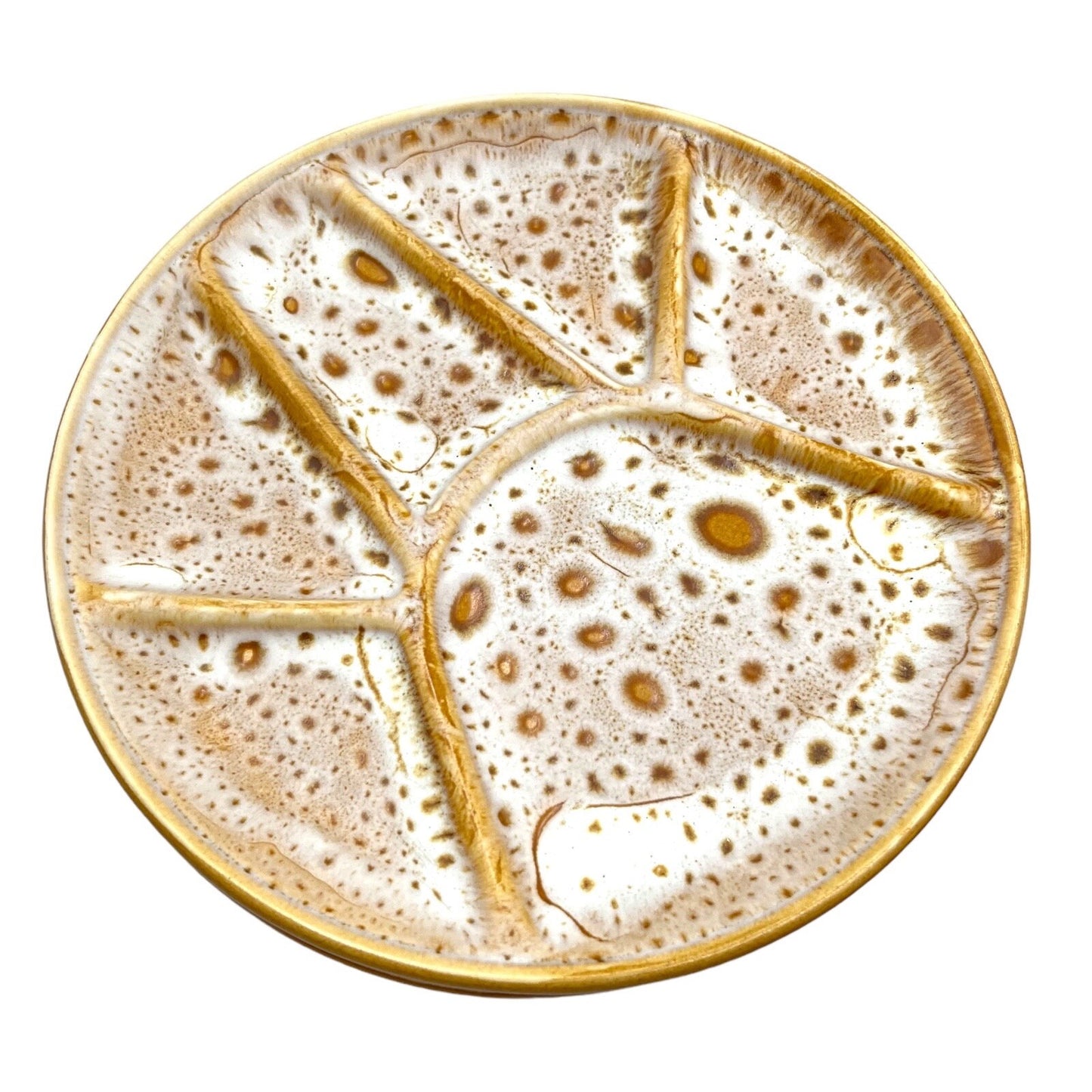Single amber and white speckled fondue plate made by Niderviller with 6 raised sections on a white background