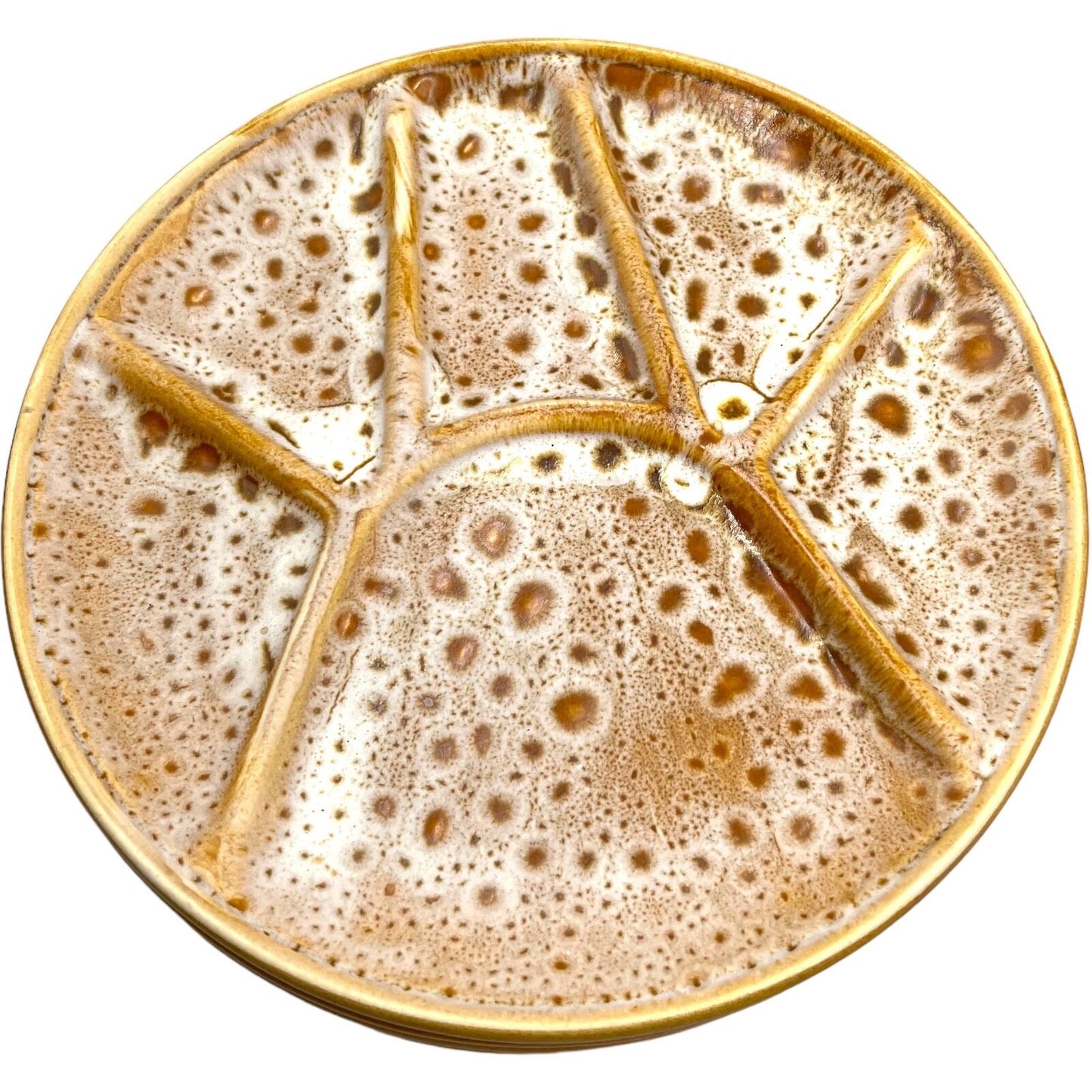 Single amber and white speckled fondue plate made by Niderviller with 6 raised sections on a white background