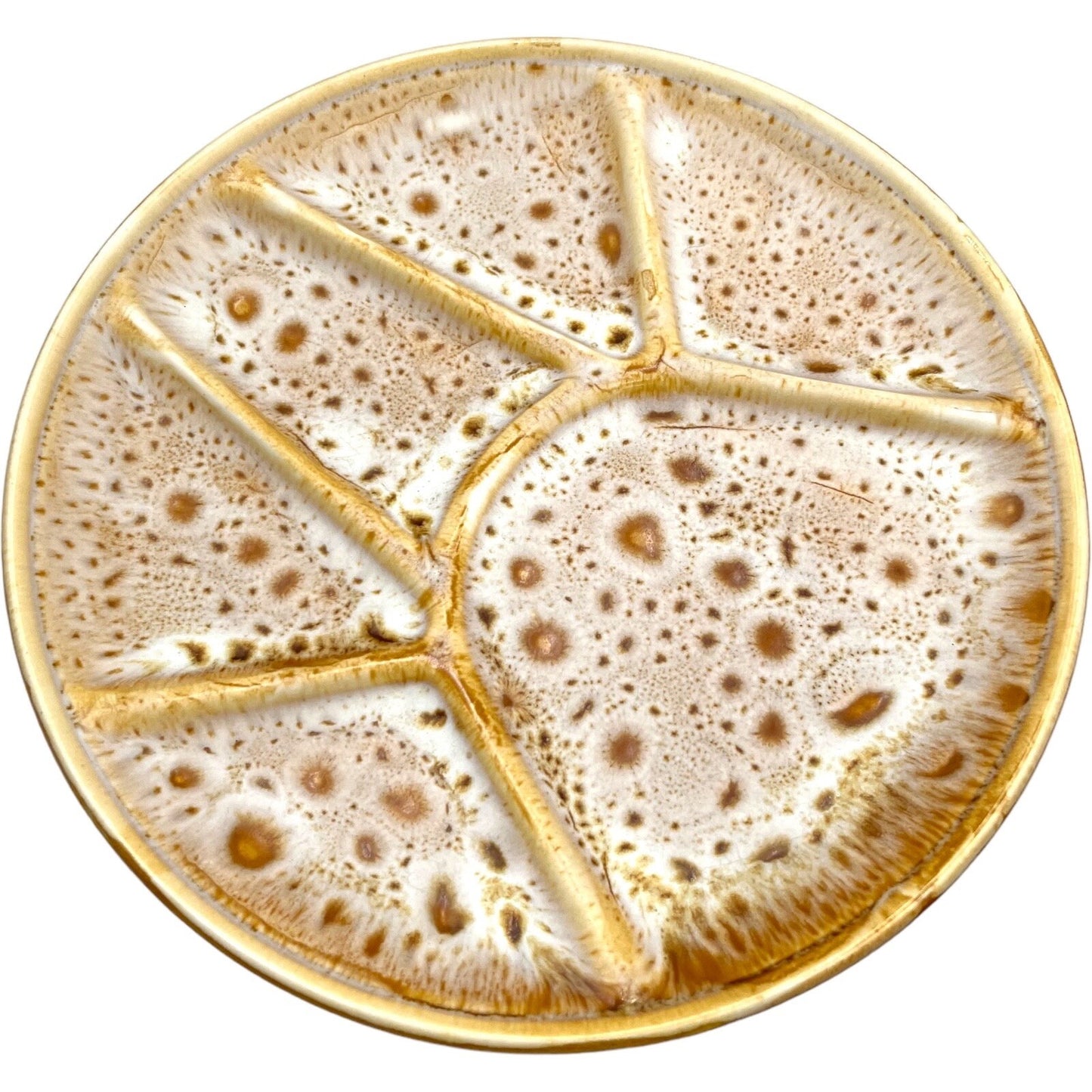 single amber and white speckled fondue plate made by Niderviller with 6 raised sections on a white background