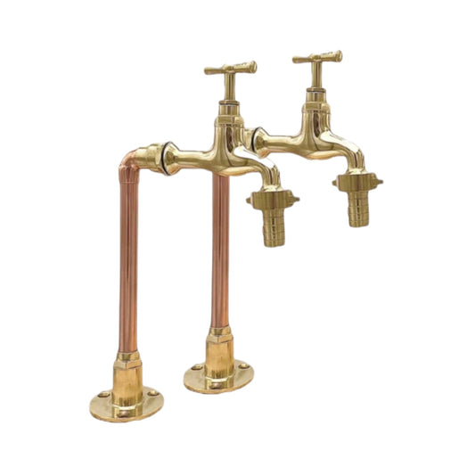A pair of traditional style brass and copper taps with detachable nozzles and visible pipework, isolated on a white background for sale by All Things French Store.