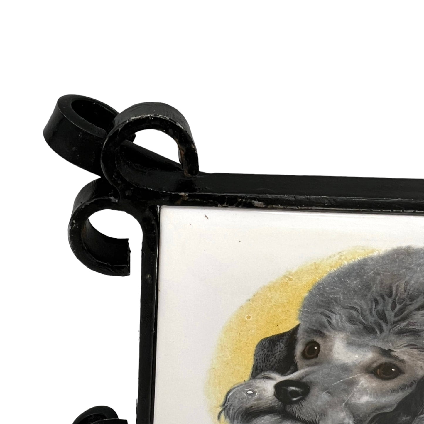 French tile topped pan trivet with an iron frame and 2 tiles -  dog pictures on a white background