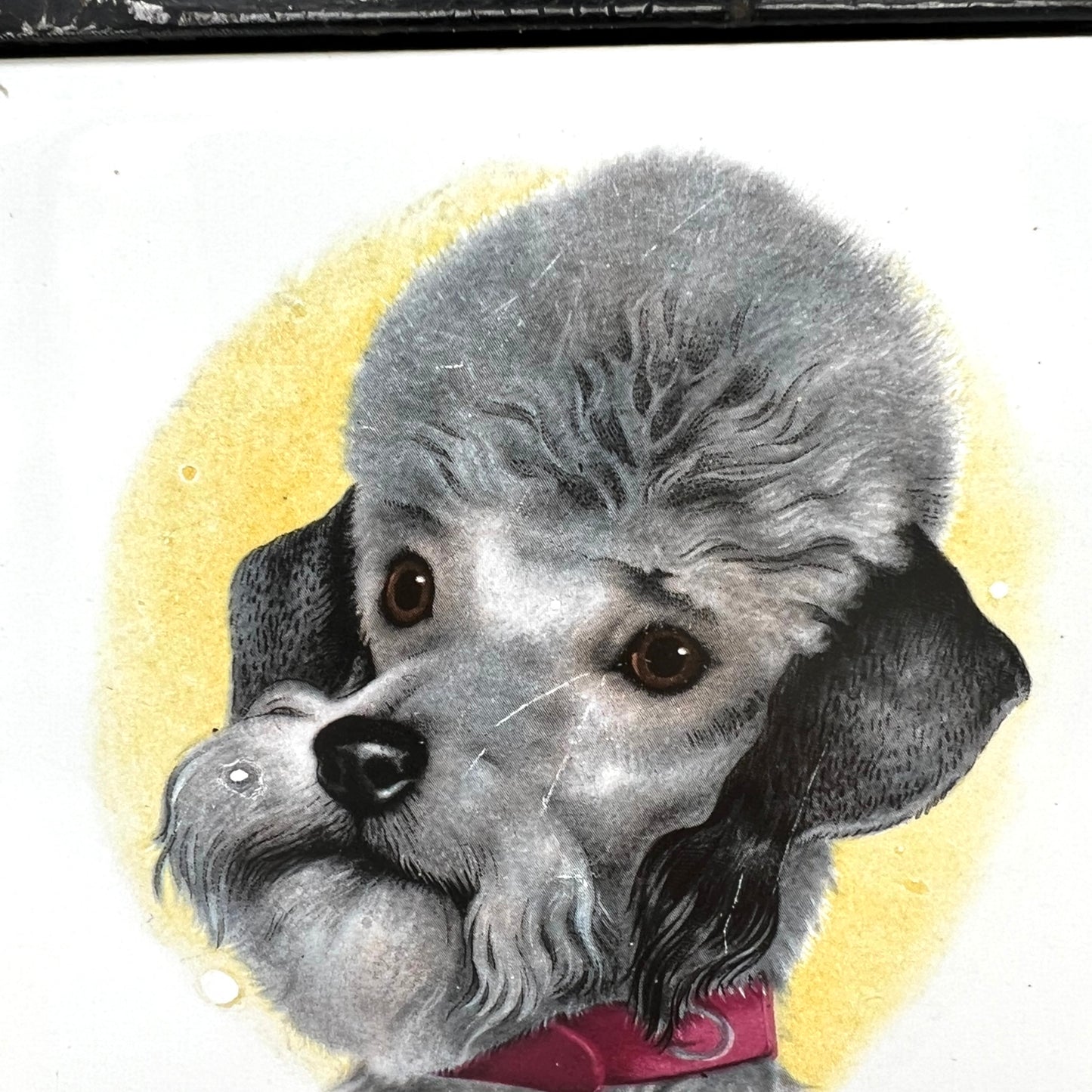 French tile topped pan trivet with an iron frame and 2 tiles -  dog pictures on a white background