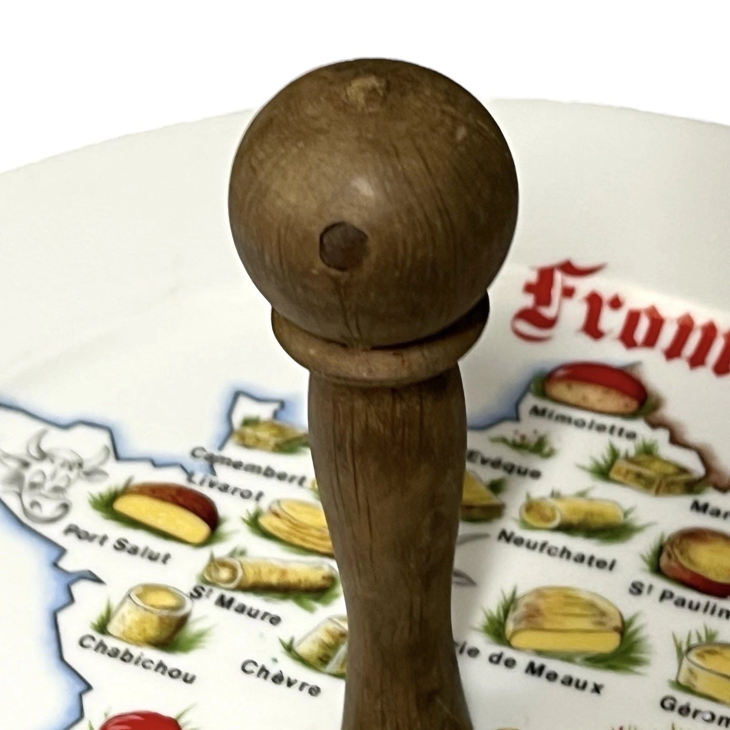 Wooden handle on a plate with cheese illustrations