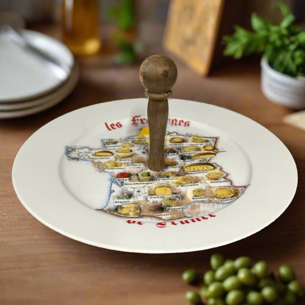 Decorative plate with map of France showing regional cheeses and wooden handle on a white background