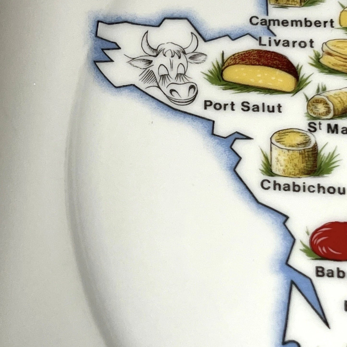 Map of France with illustrations of cheese and a cow, labeled 'Port Salut' and 'Chabichou'.
