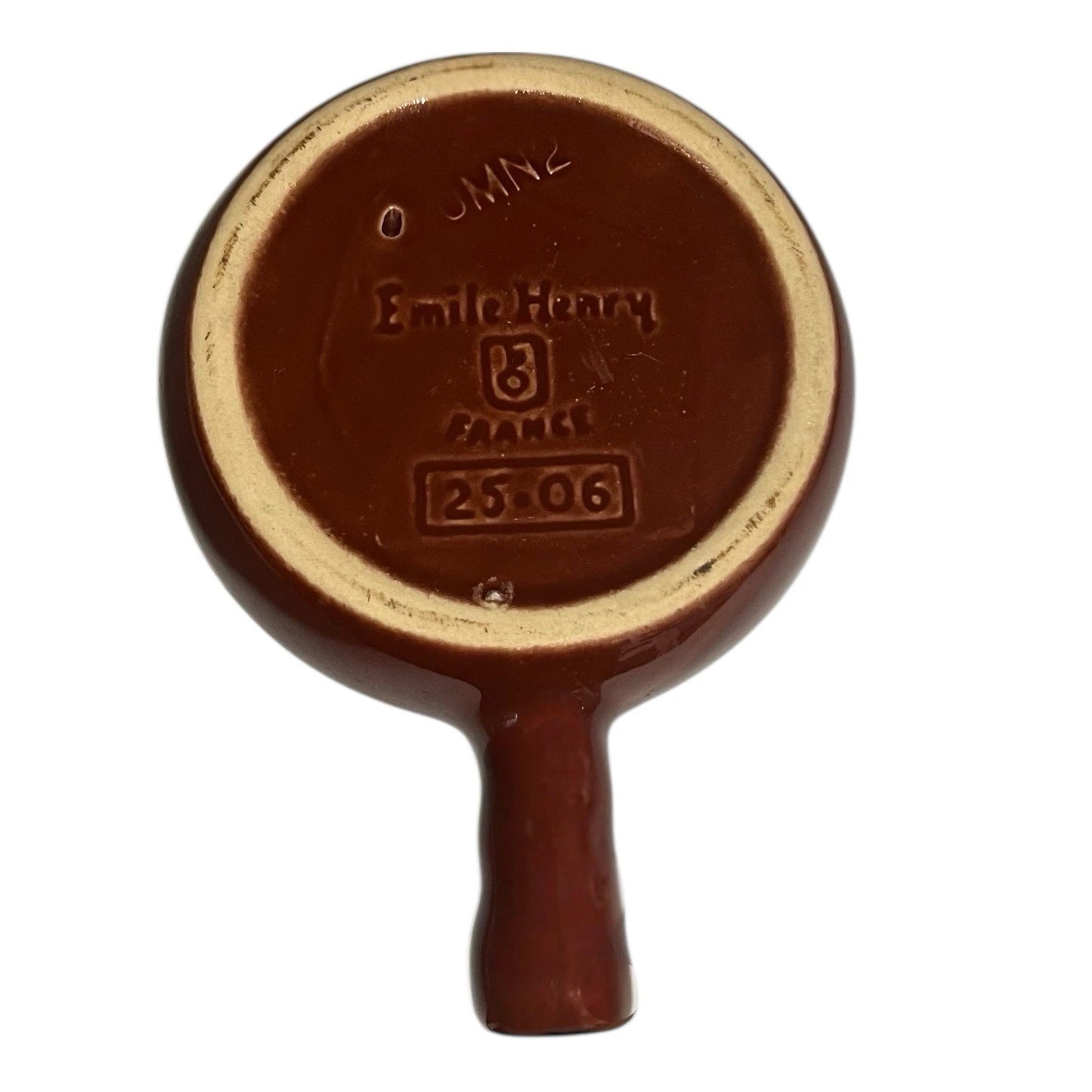Reverse of a French brown and cream ceramic escargots dish or plate with the Emile Henry makers stamp on a white background