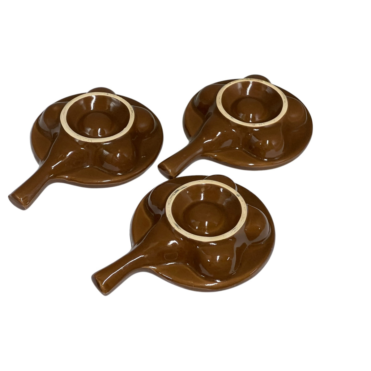 Underside of 3 snail plates on a white background 