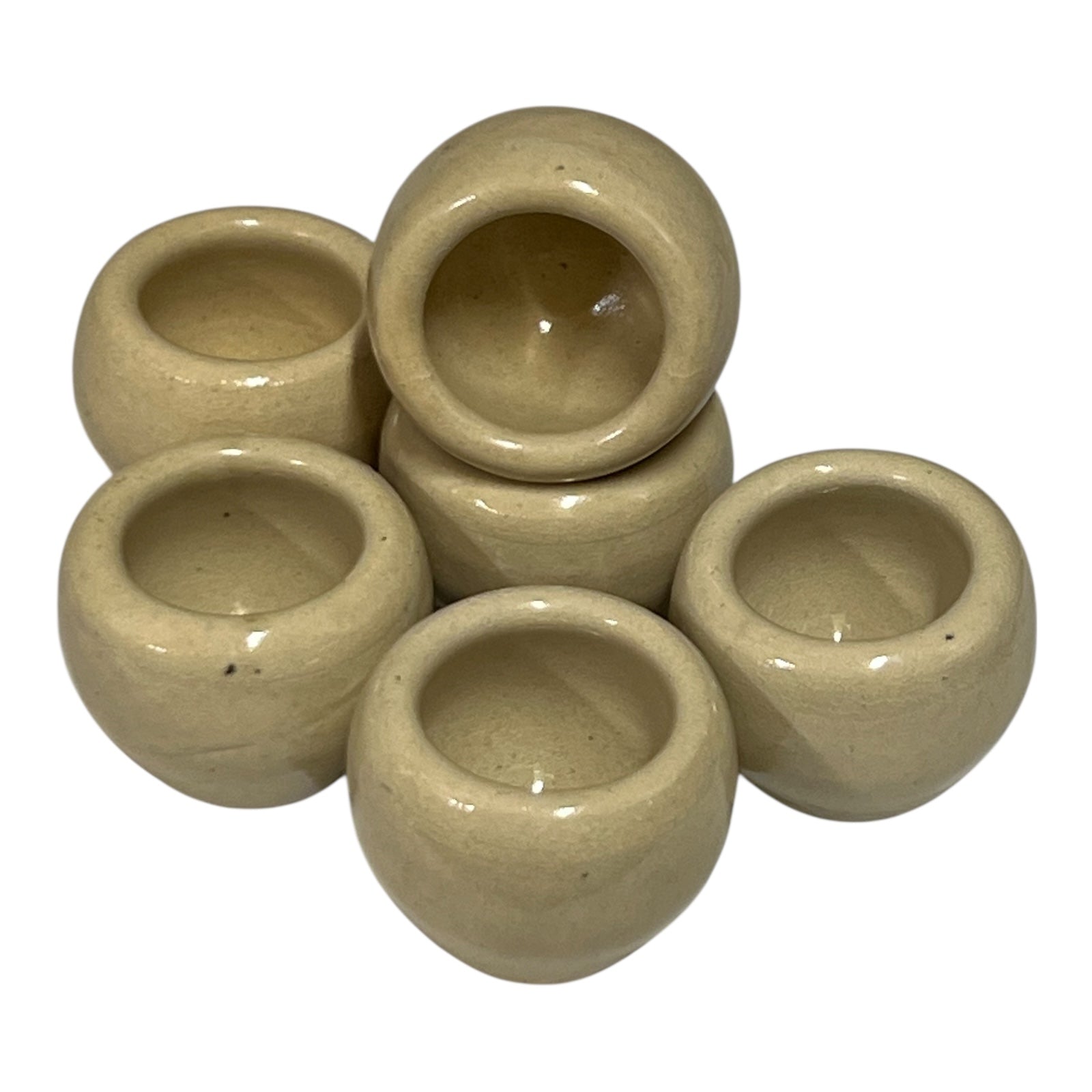 Set of beige ceramic escargots snail cups on a white background