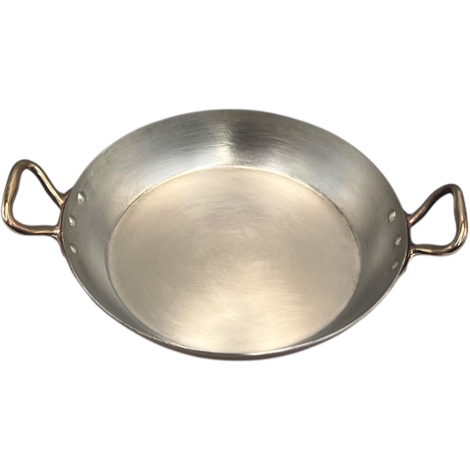 French copper round gratin pan with brass handles and hand wiped tin lining on a white background