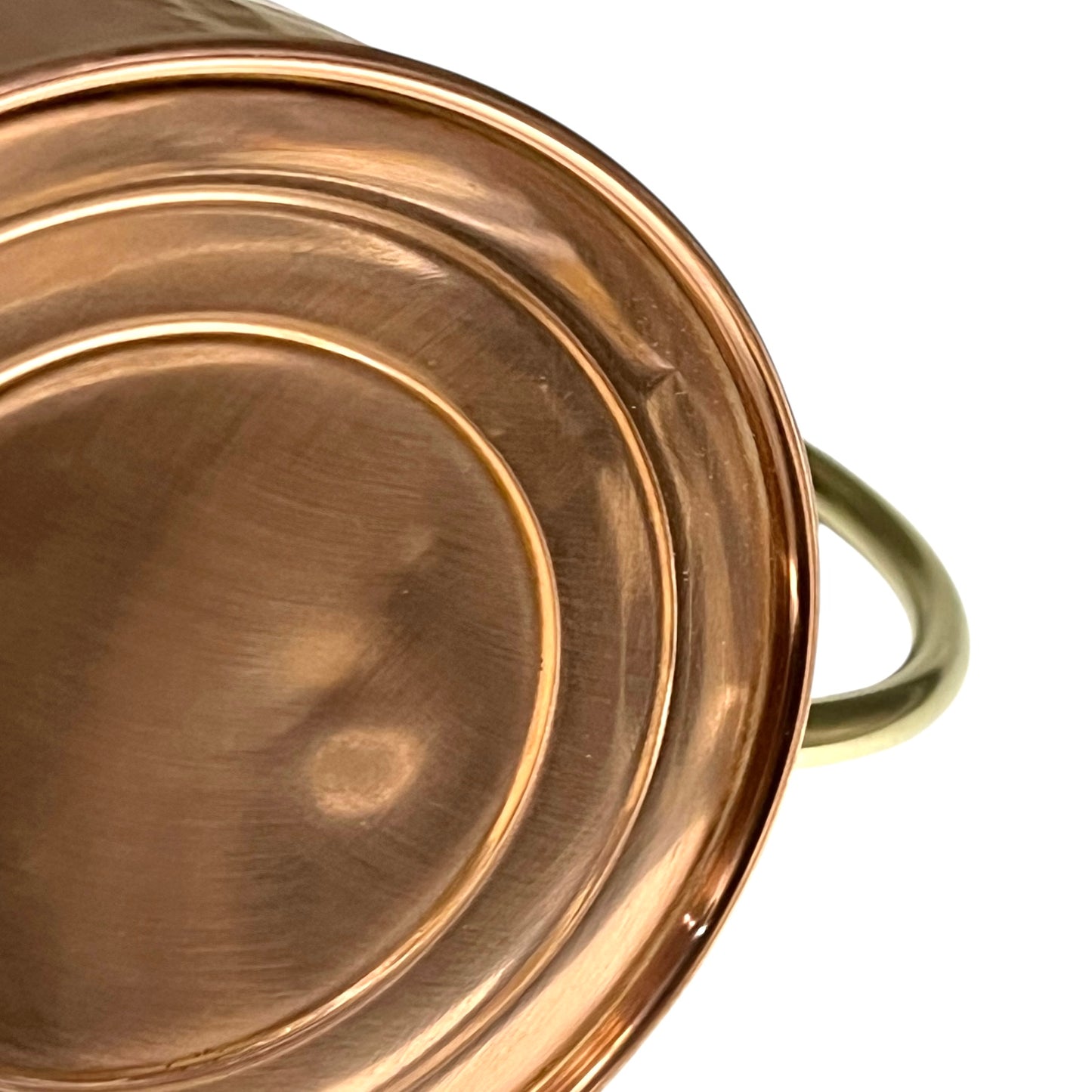 Close up of copper and brass watering can on a white background