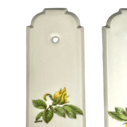 close up of door push plate with a yellow rose decoration on a white background