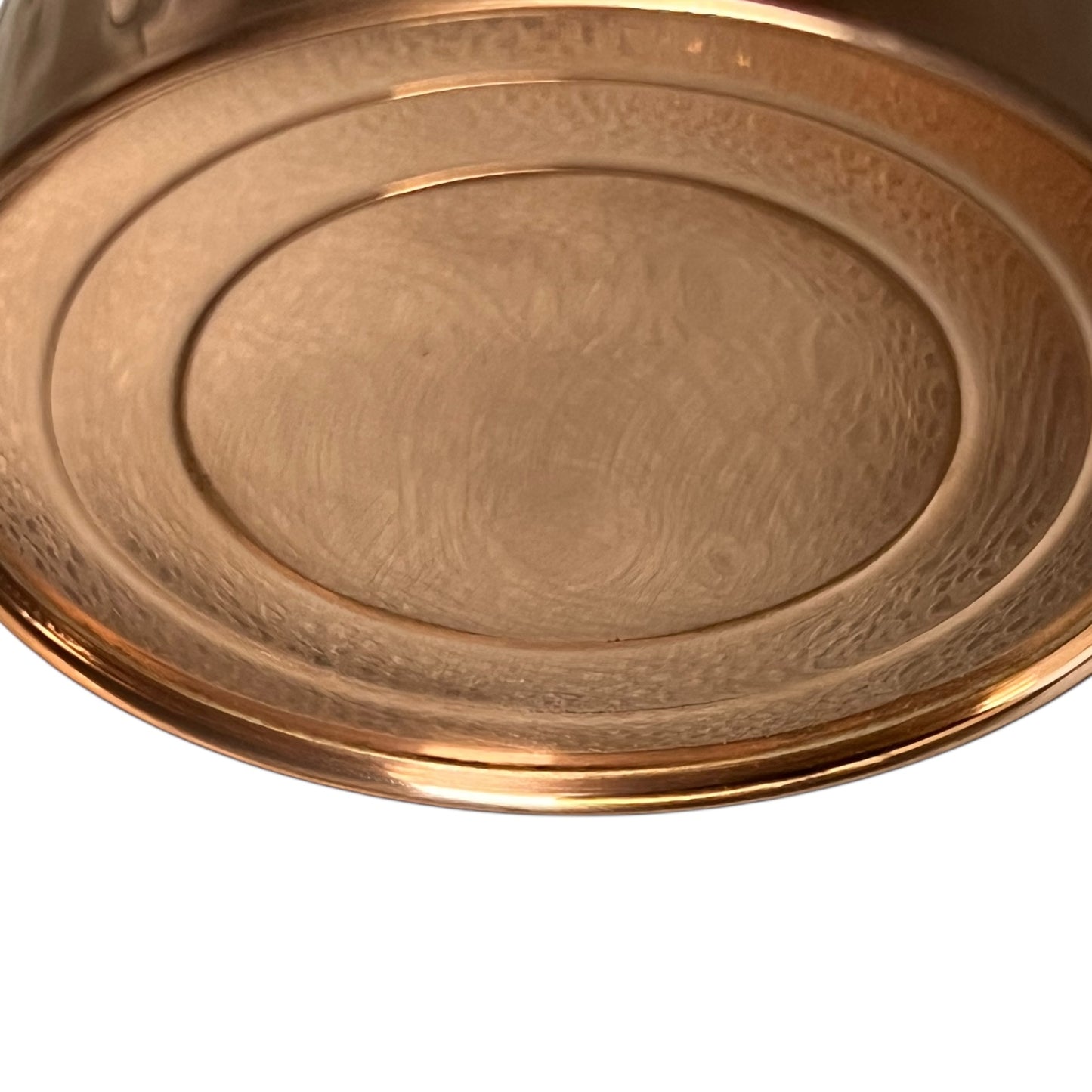 Close up of copper and brass watering can on a white background