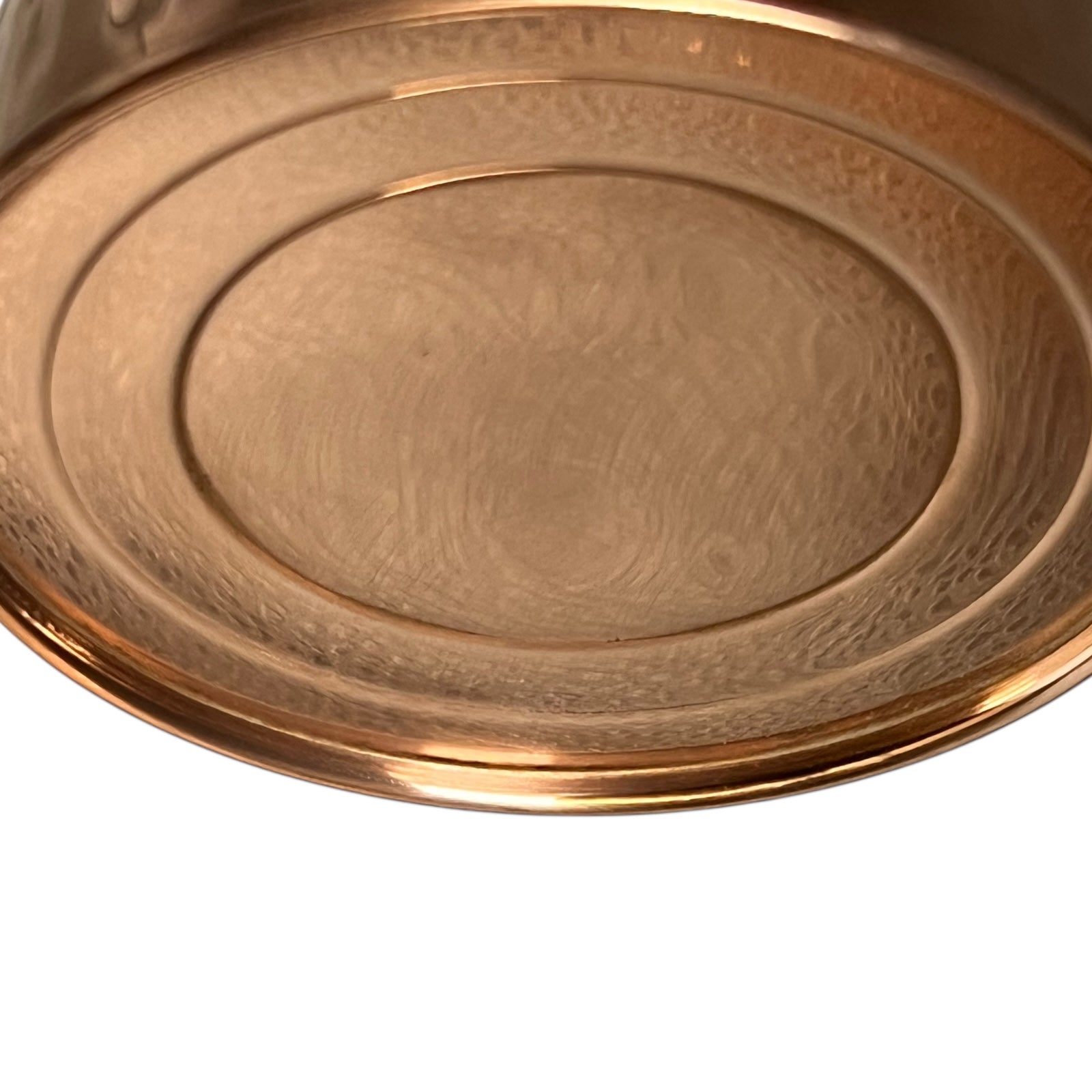 Close up of copper and brass watering can on a white background