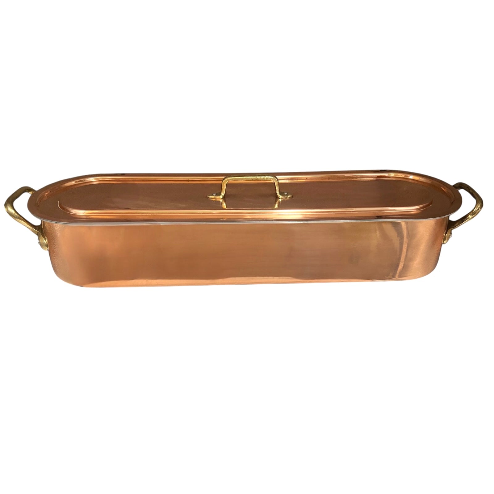 Copper French fish poaching pan with lid on a white background