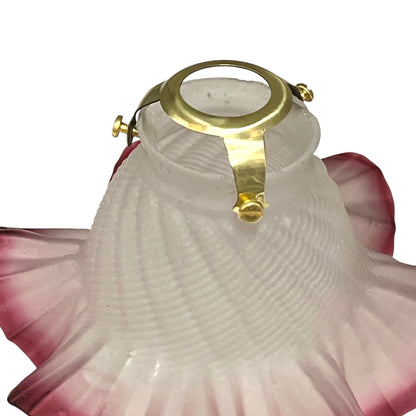 Decorative lamp with gold ring and pink floral design on a white background
