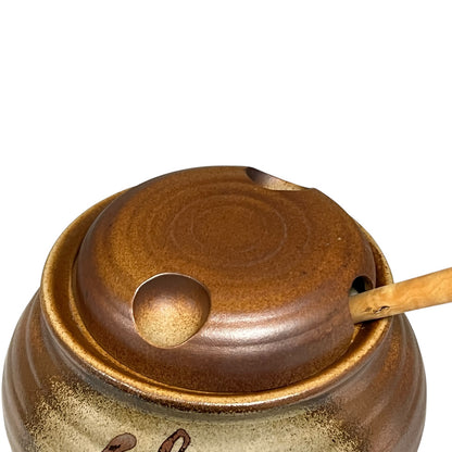Close-up of a ceramic container with 'Olive' engraved on it, on a white background.
