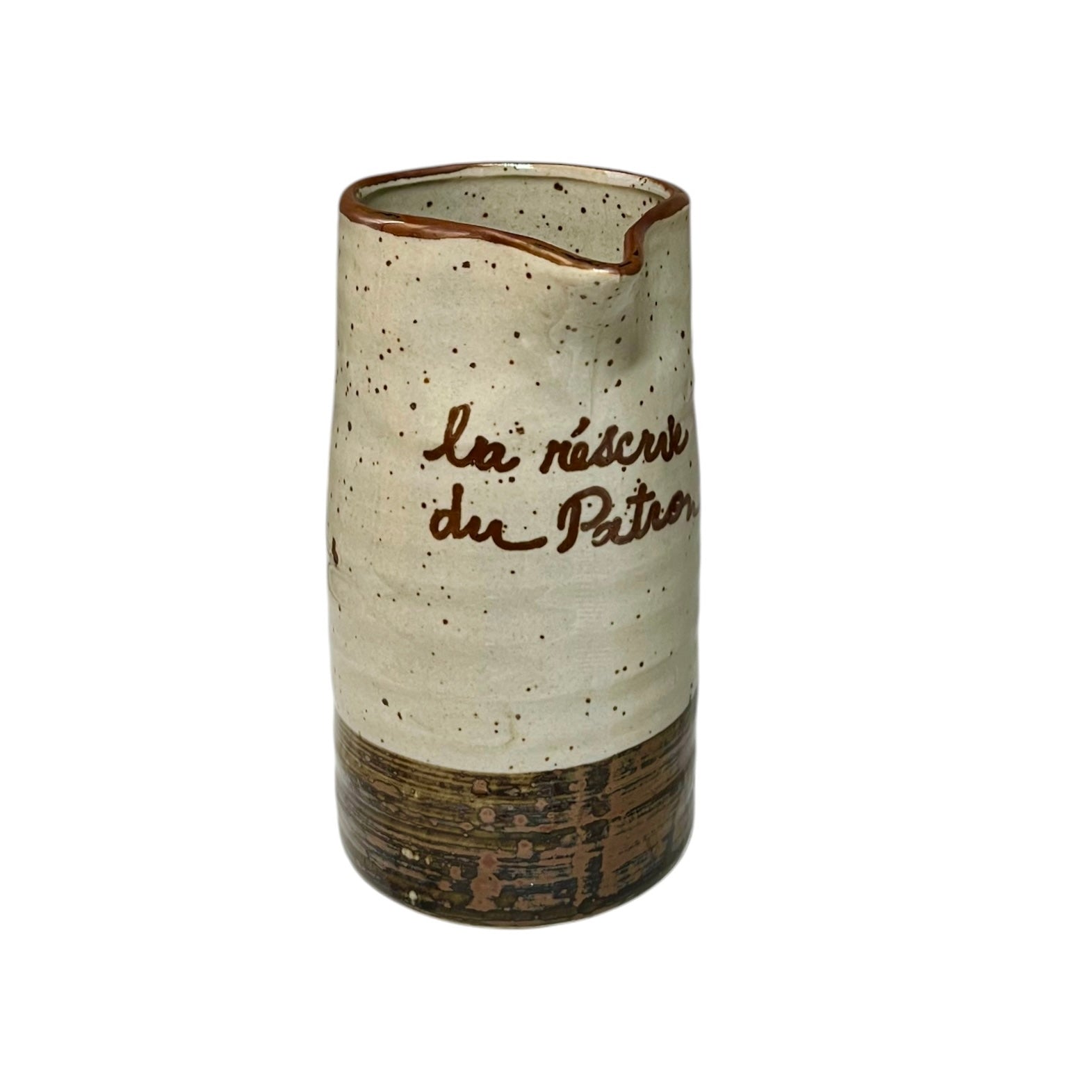 Ceramic speckled brown and cream vase with French text on a white background
