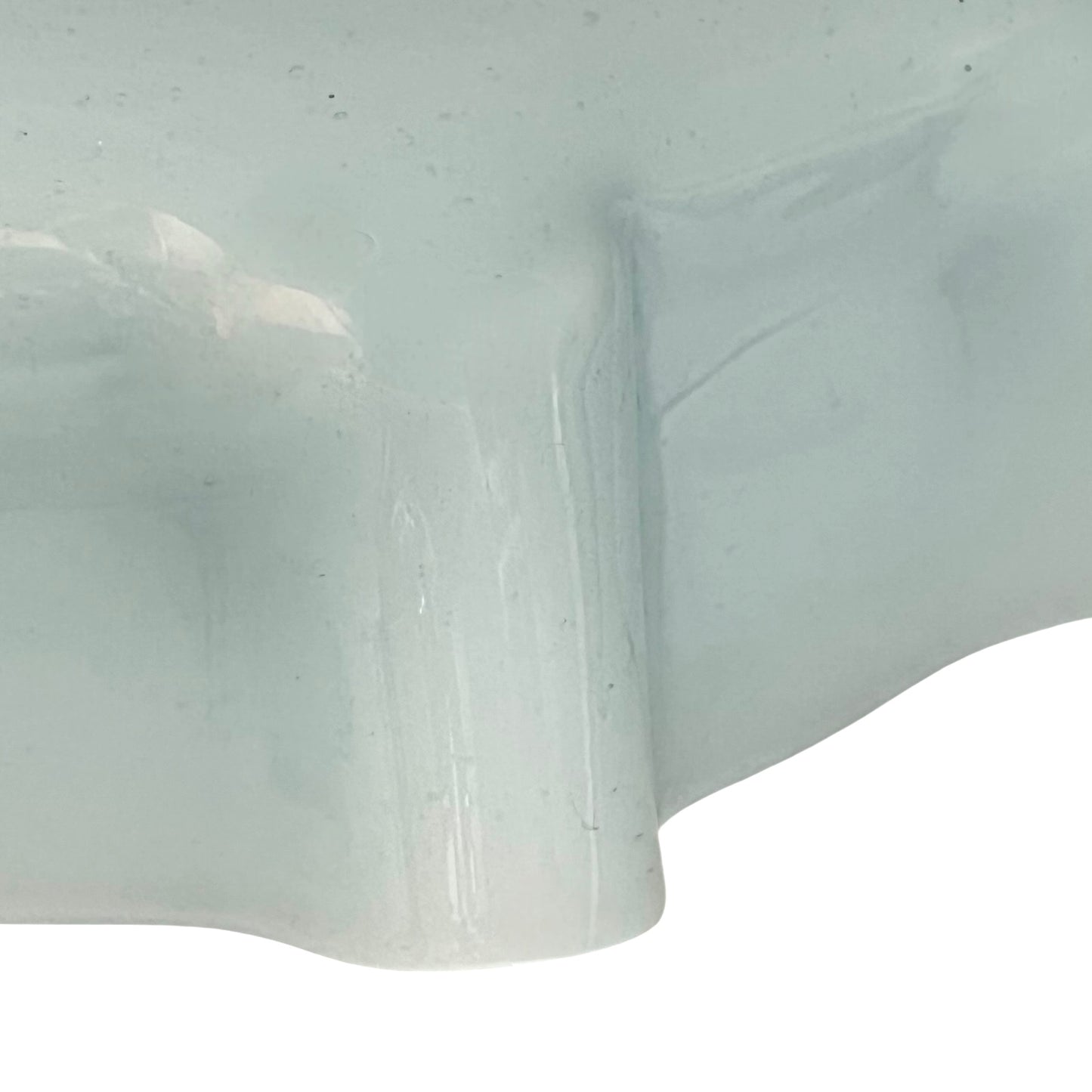 Close up of vintage blue glass lamp shade with brass fitting on a white background