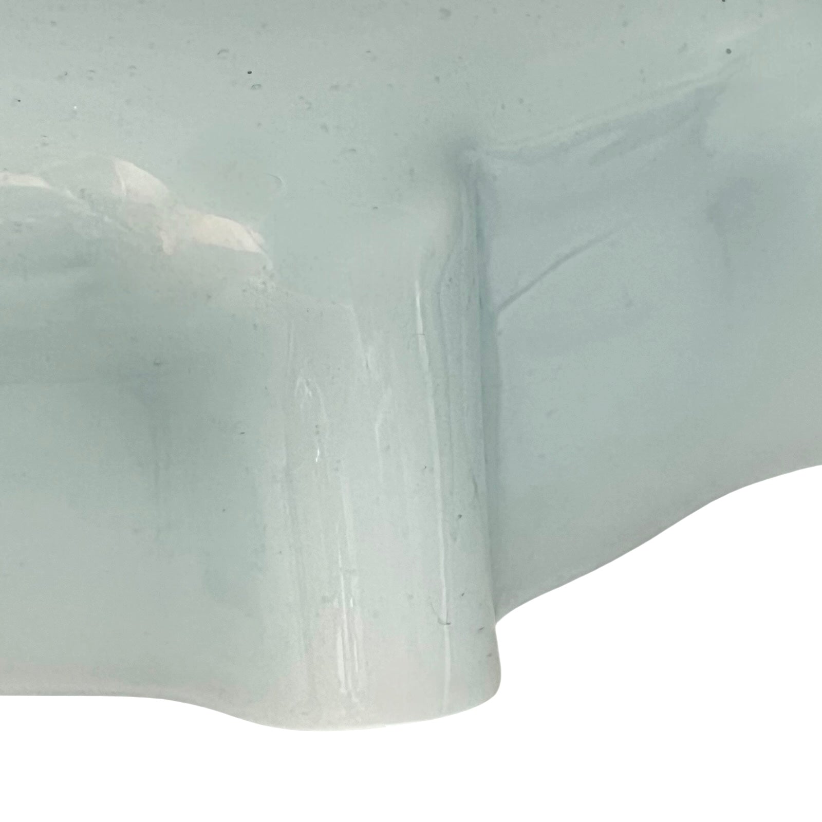 Close up of vintage blue glass lamp shade with brass fitting on a white background