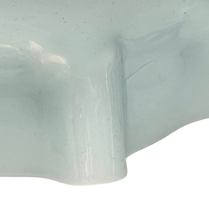 Close up of vintage blue glass lamp shade with brass fitting on a white background