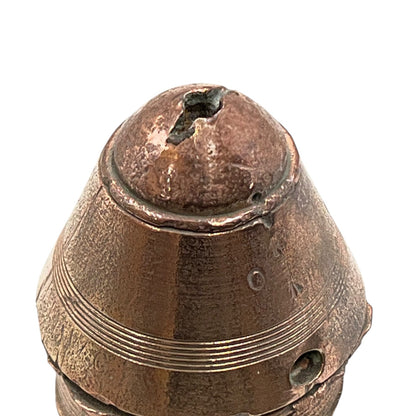 WW1 brass fuse paperweight on a white background