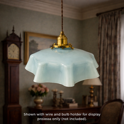 Vintage-style pendant light with a decorative shade in a room setting.