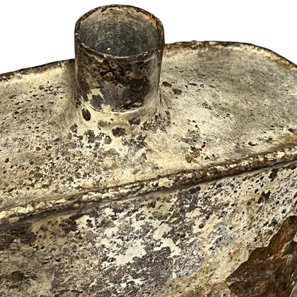 close up of a rusty water bottle on a white background 