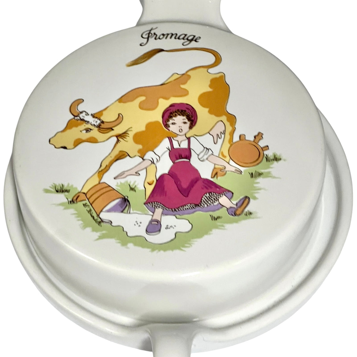 Close up of a vintage French L'Hirondelle porcelain cheese dish with cow-shaped white base and illustrated Fromage lid, traditional French farmhouse cheese server.