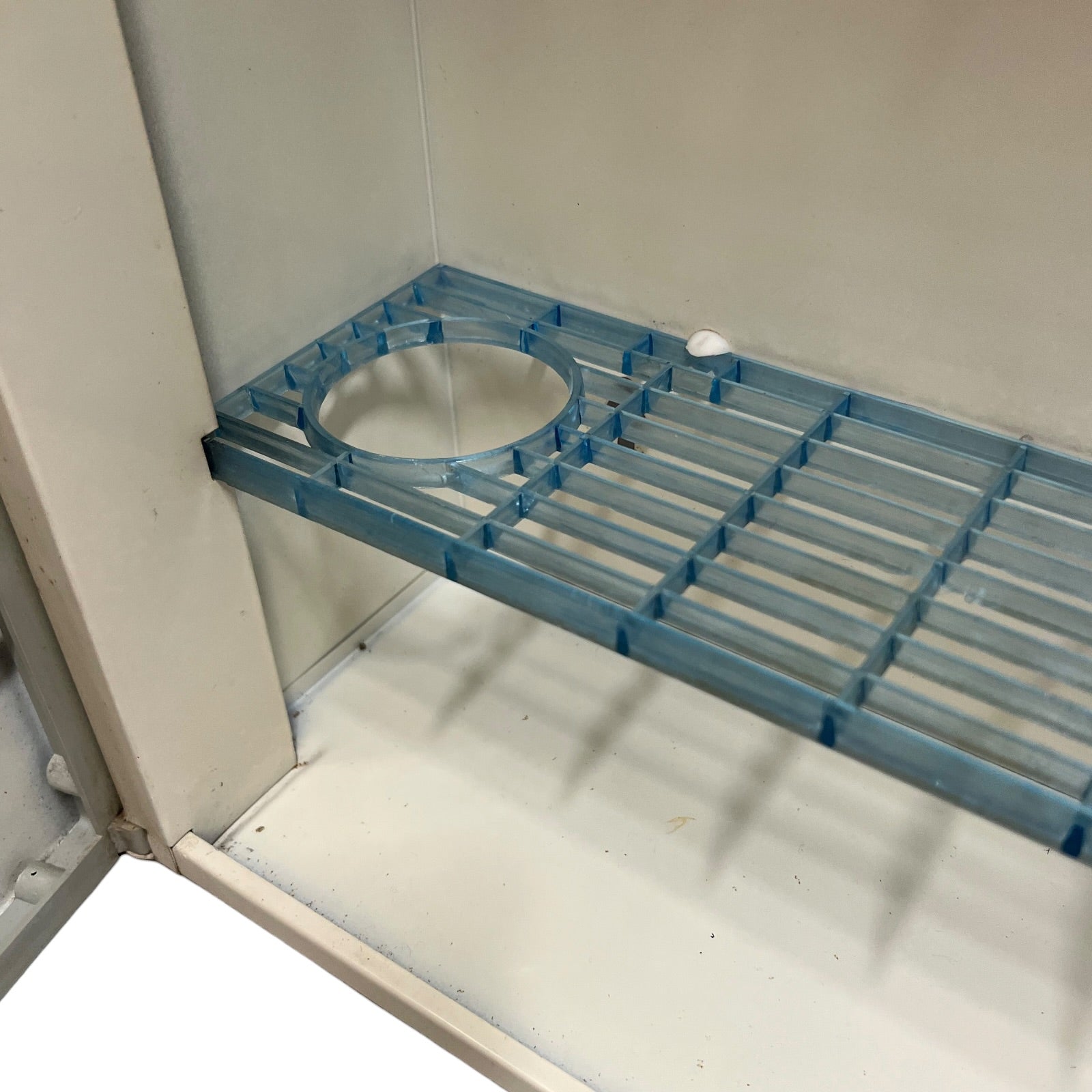 close up of a vintage metal bathroom cabinet inside view on a white background