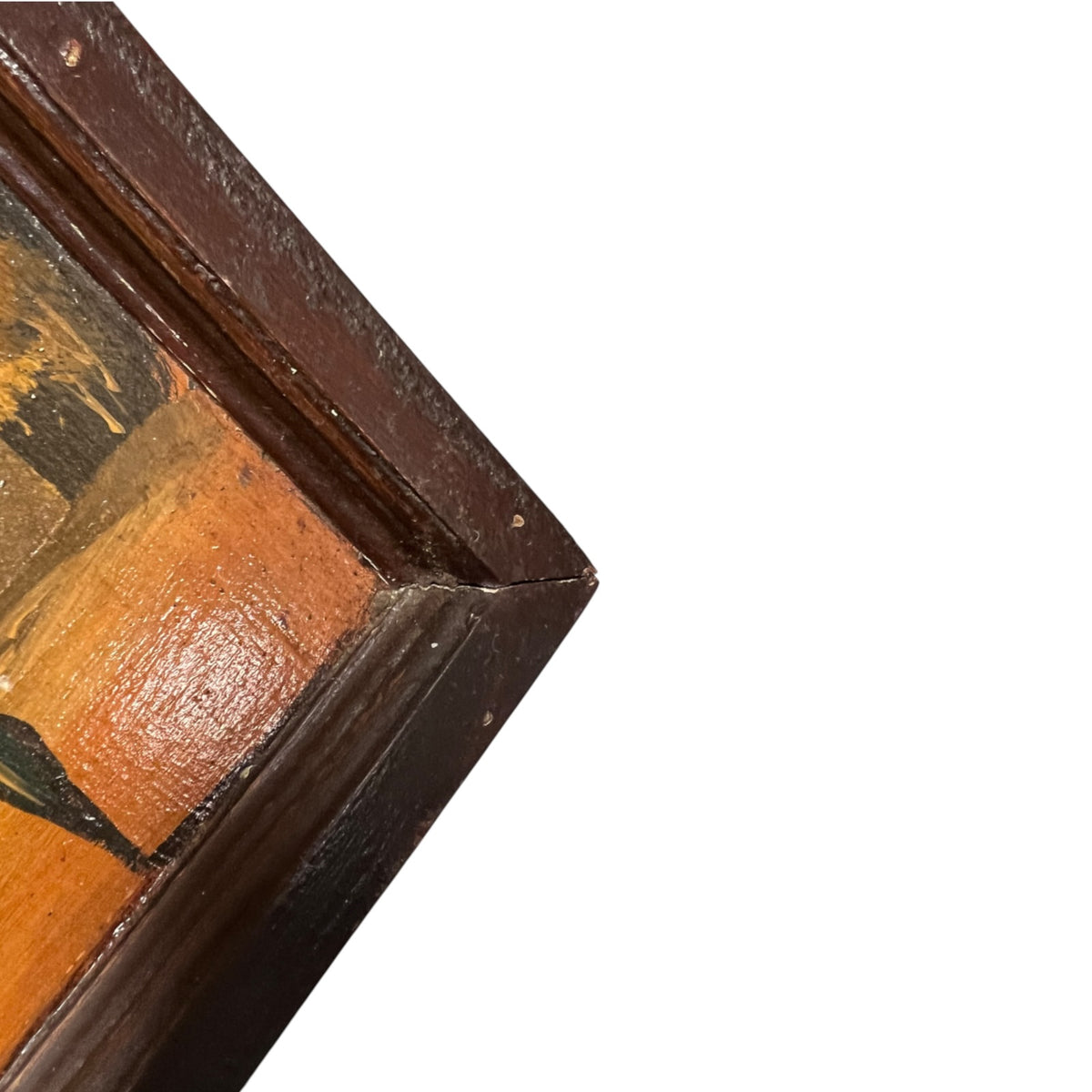 Close-up detail of a framed painting corner, showing a dark brown wooden frame with visible wear and a warm orange-brown painted surface against a white background.