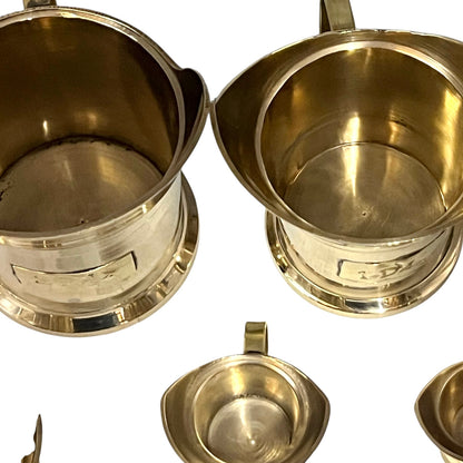 Set of brass cups on a white background