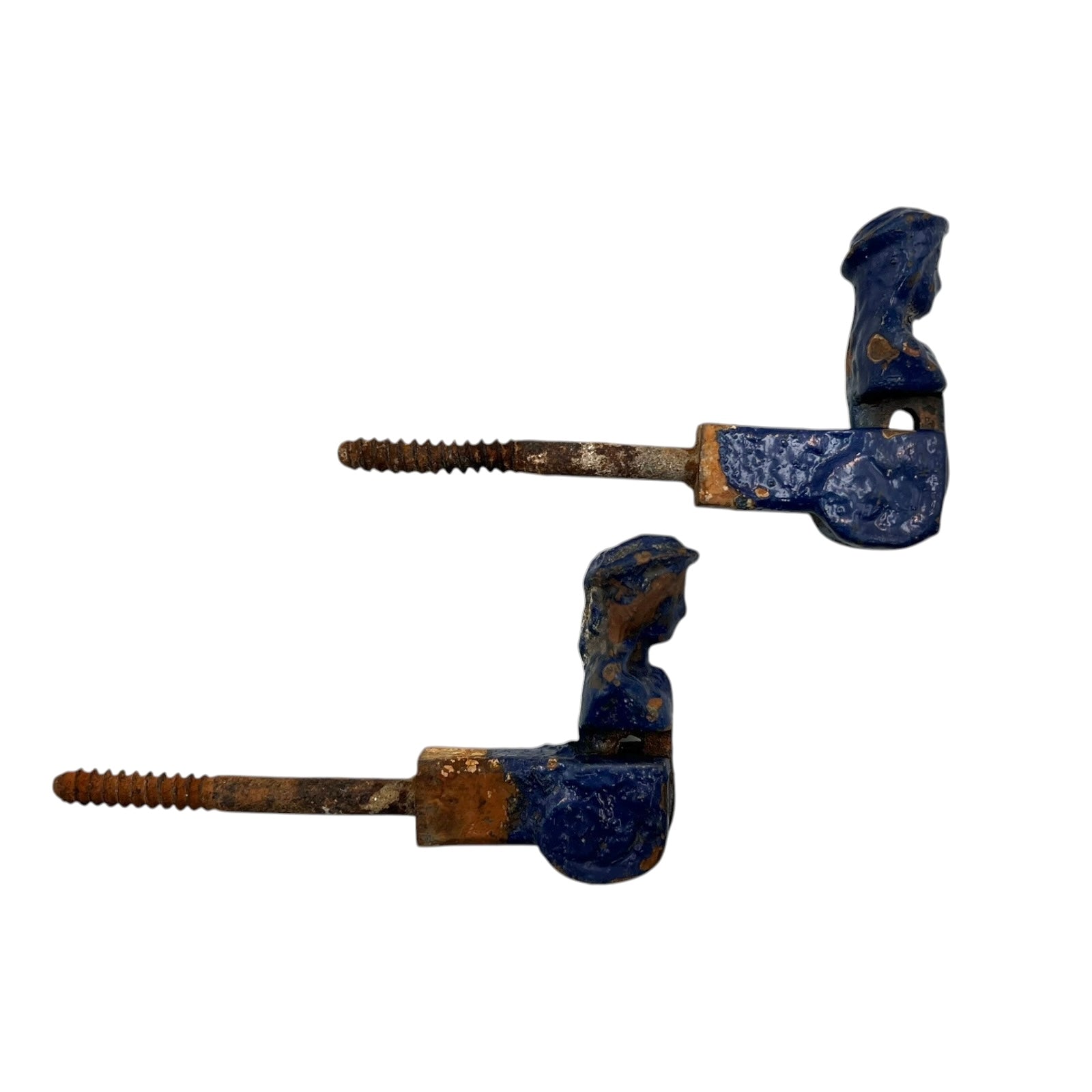 Pair of French cast iron shutter dogs painted blue with signs and age and wear on a white background