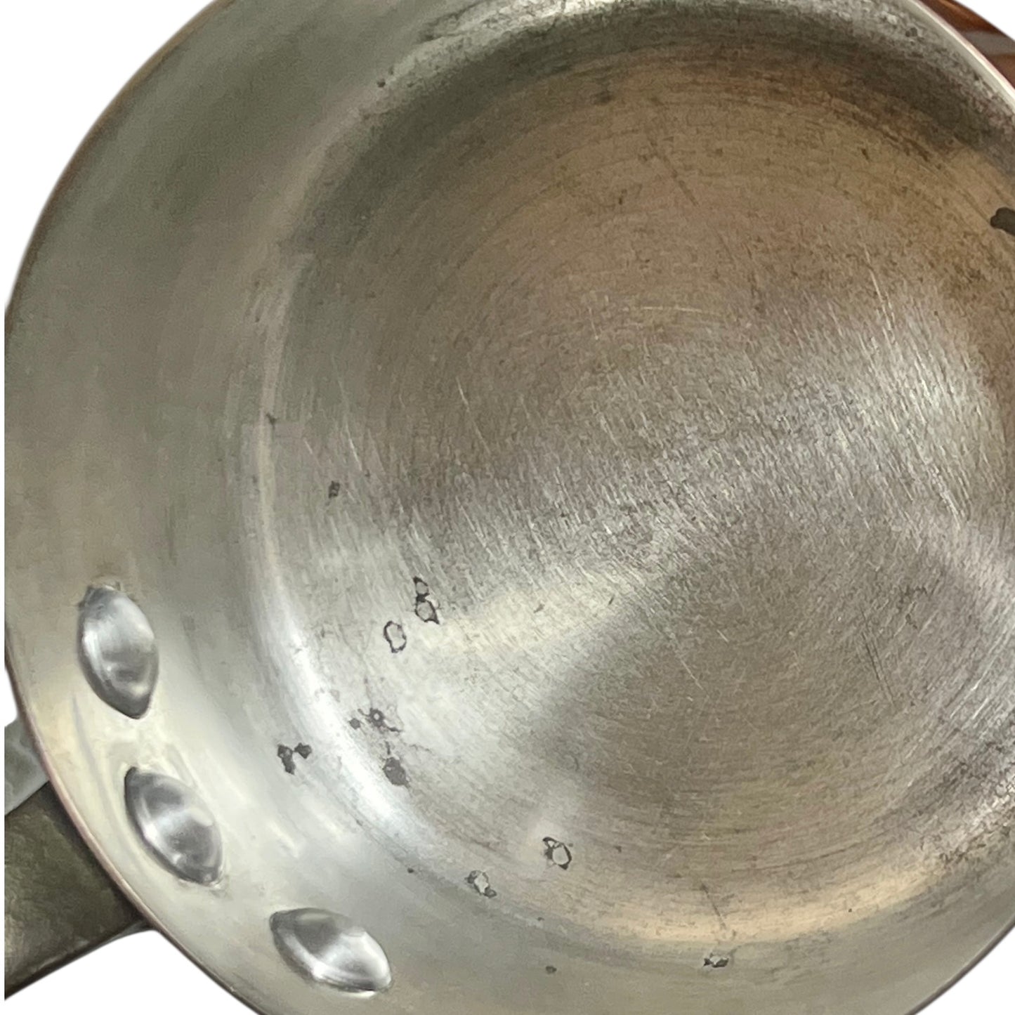 Close-up of copper cookware with iron handles on a white background