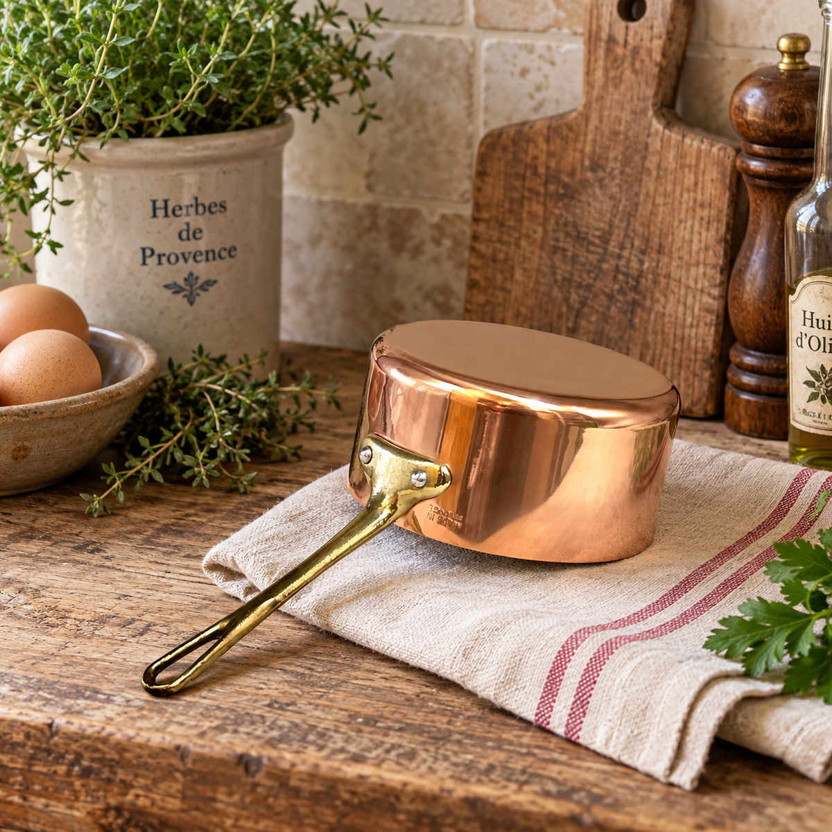 Small copper saucepan on a farmhouse kitchen table 