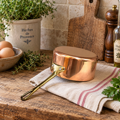 Small copper saucepan on a farmhouse kitchen table 