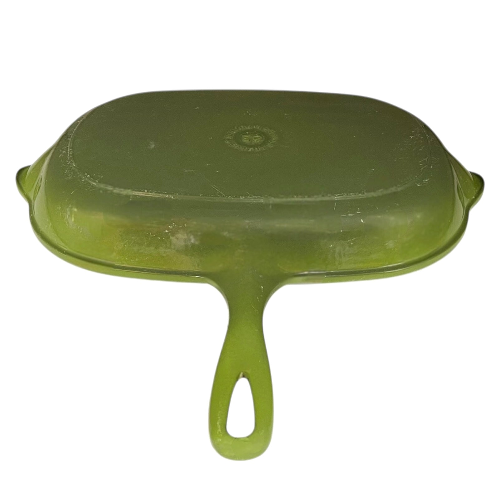 Green Le Creuset grill pan with black cast iron inner on a white background